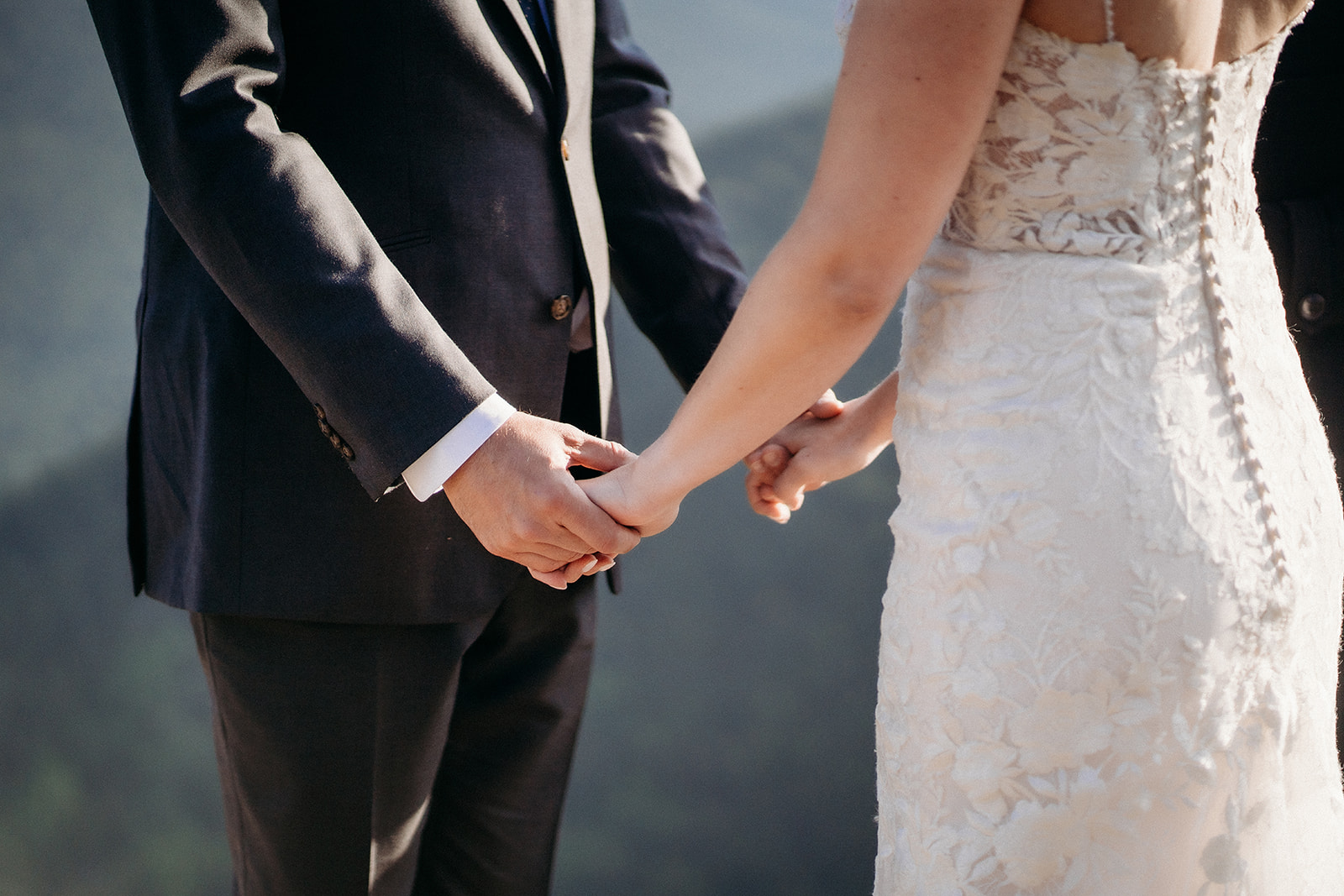 A close-up of the couple holding hands, a quiet moment full of meaning during their elopement in Colorado.