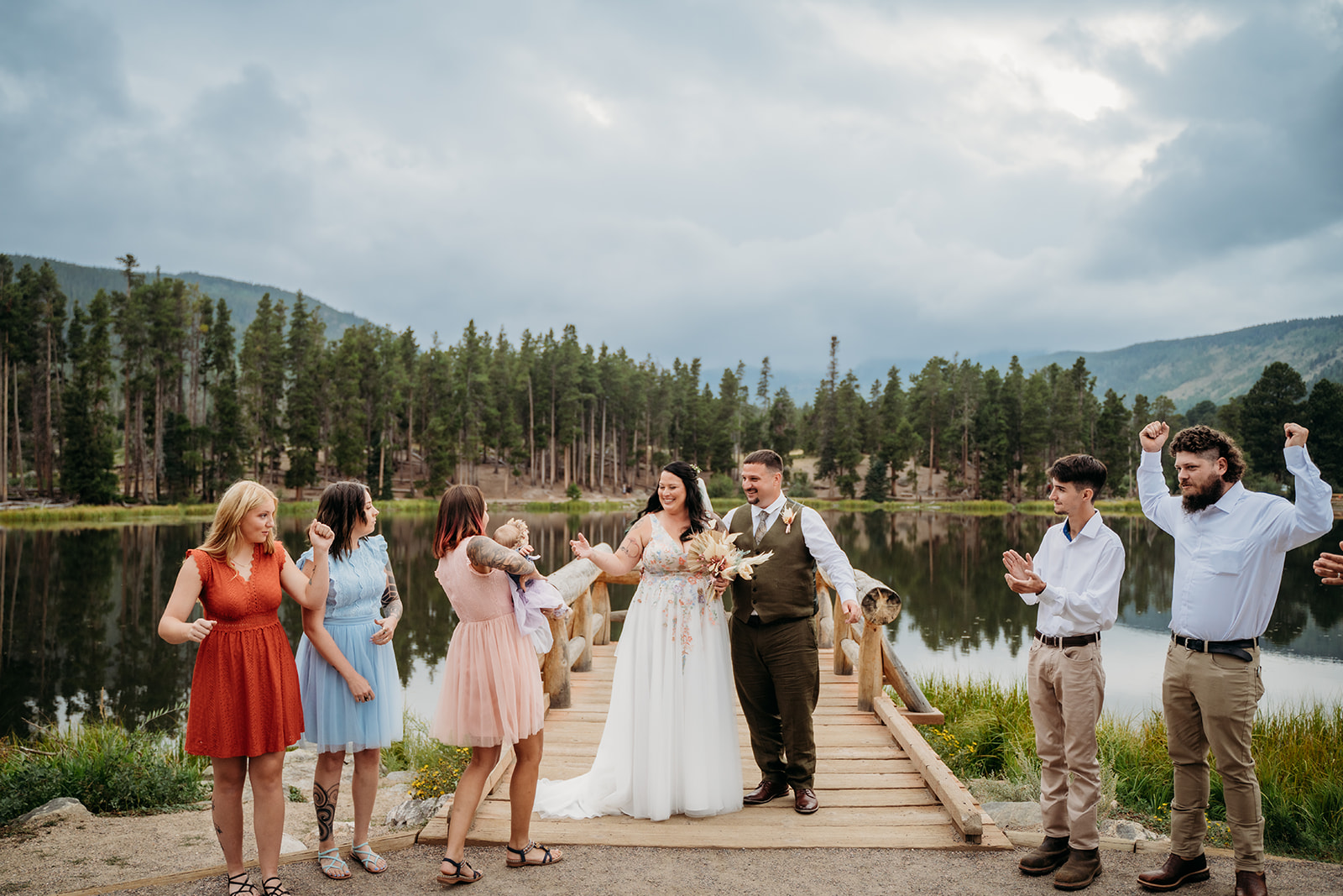Just married couple celebrates with loved ones after saying “I do,” during their joyful and emotional intimate wedding.