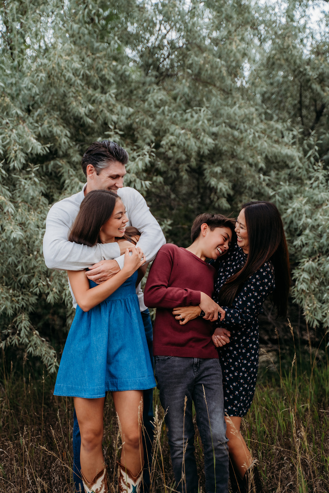 A joyful family group hug in the middle of the field—capturing love, laughter, and connection in nature.