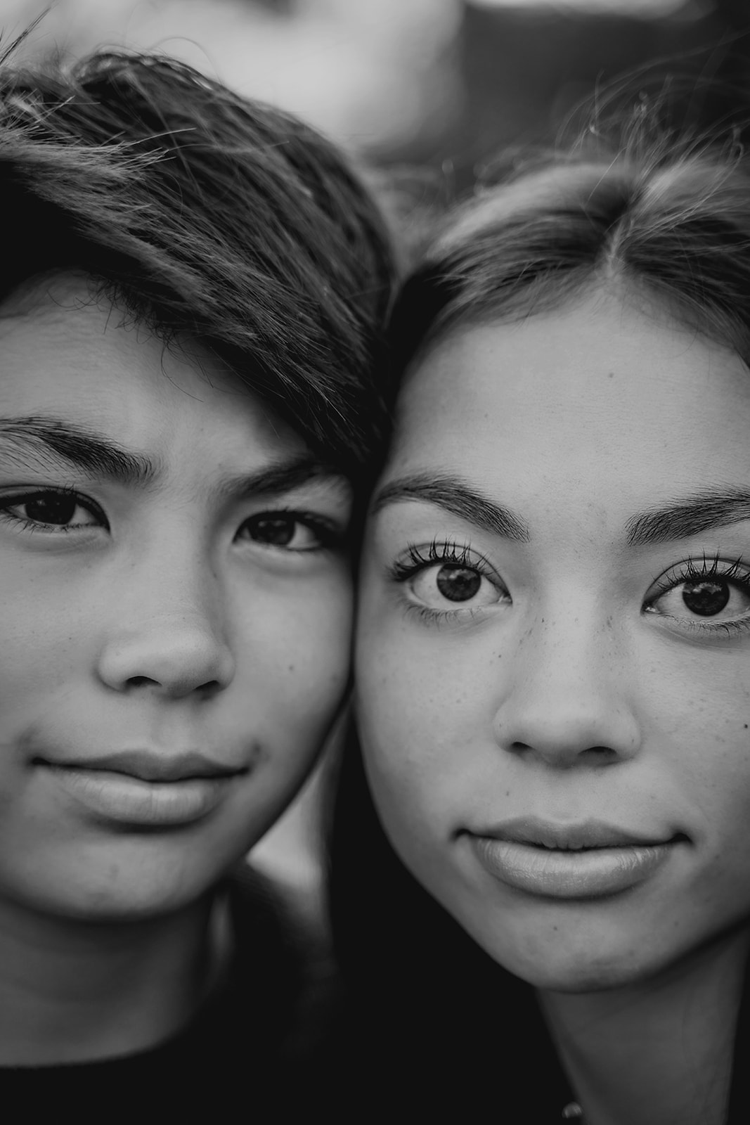 A close-up black-and-white portrait captures the striking features and bond between brother and sister.