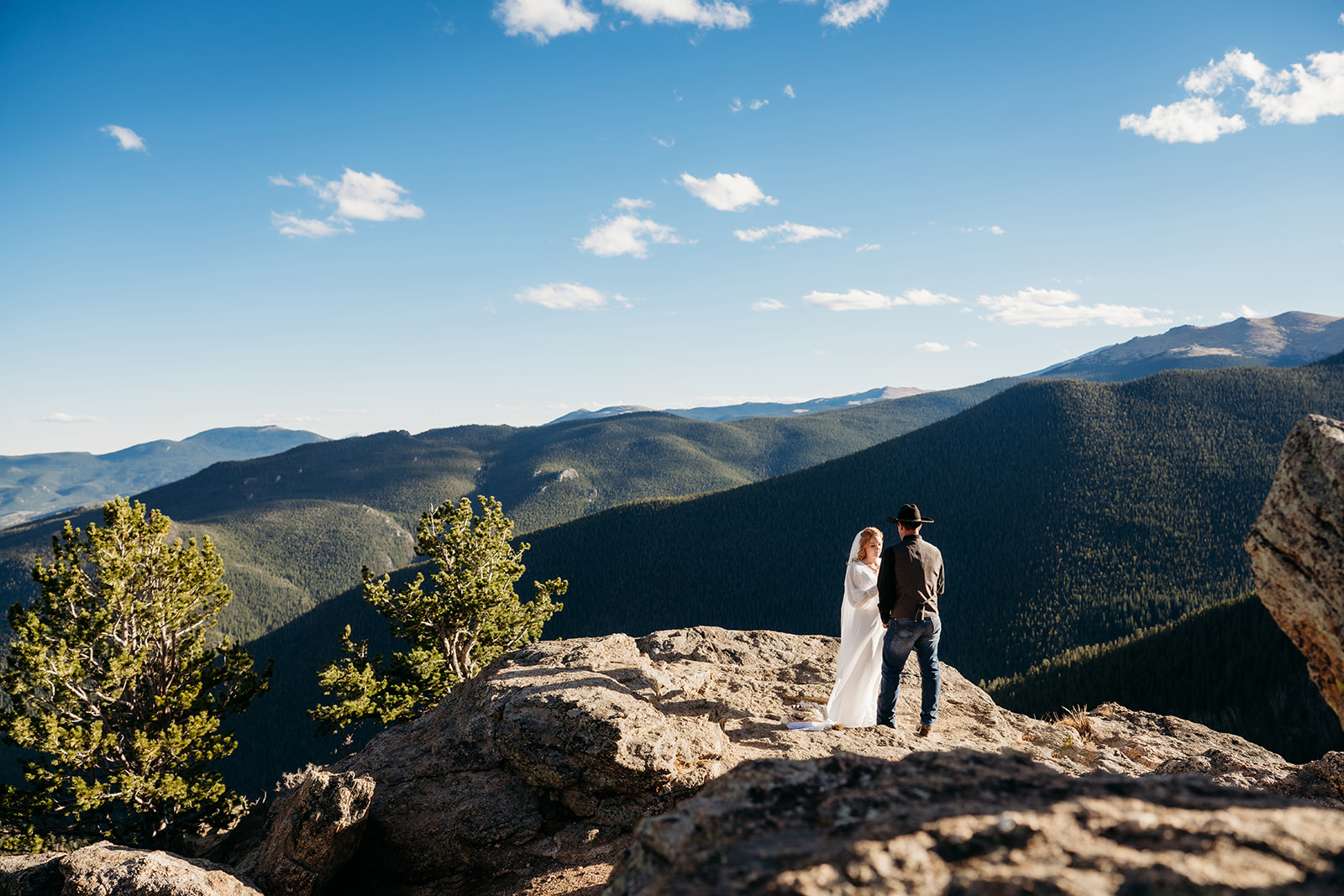 Bride and groom holding hands on a cliff’s edge, taking in the sweeping views after sharing vows they wrote themselves.