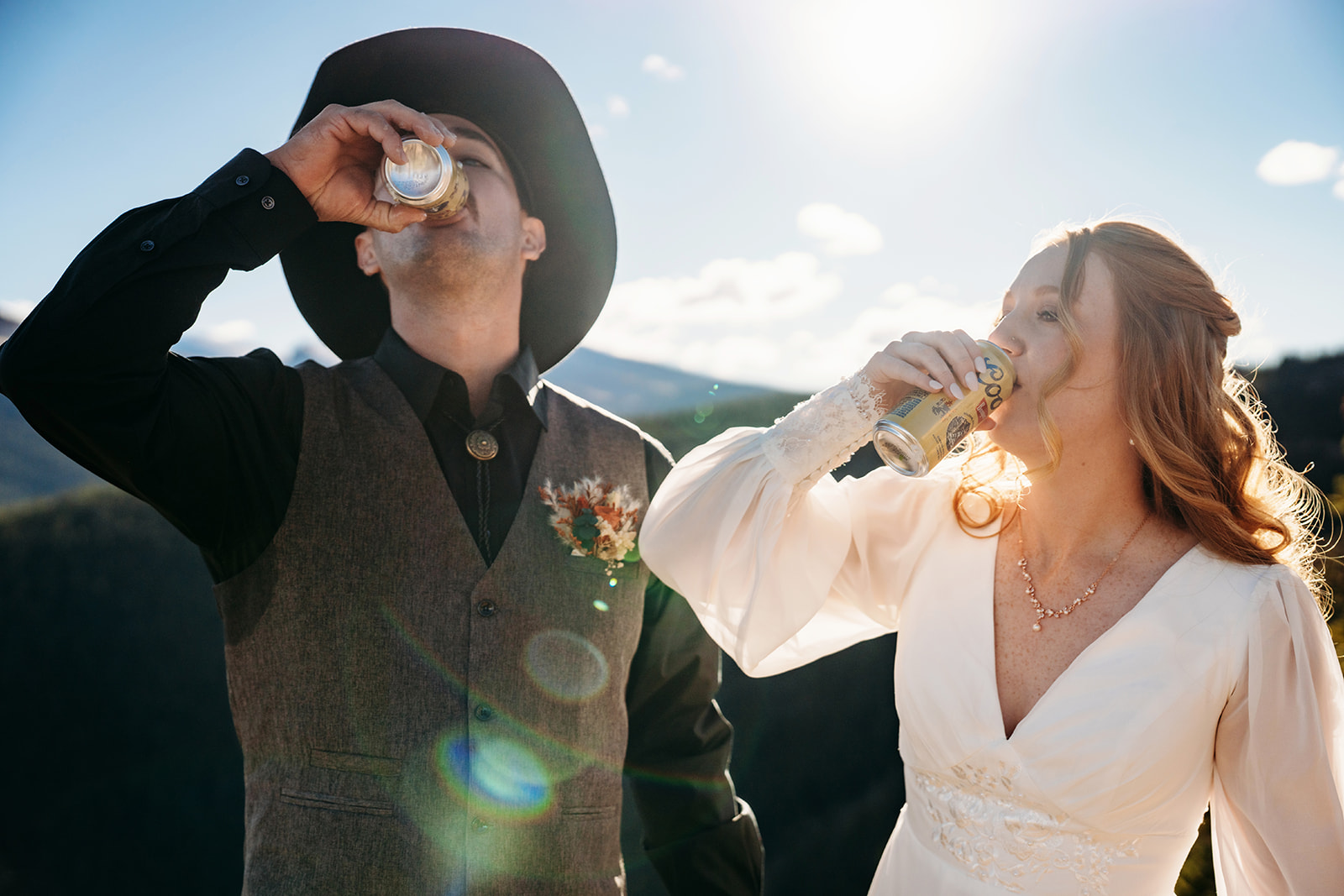 Couple cheers with beers on their elopement day, relaxed and joyful after nailing how to write vows that made them both tear up and laugh.