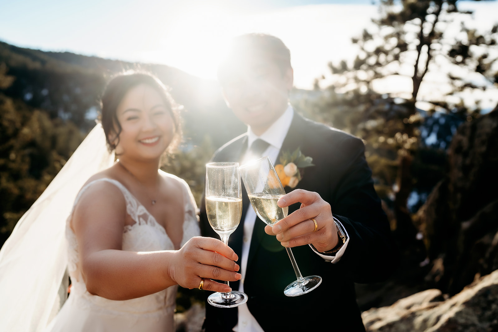 Newlyweds toast with champagne flutes, golden light glowing around them.